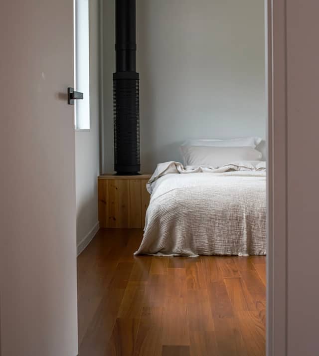 Hardwood floor in a furnished bedroom with natural light
