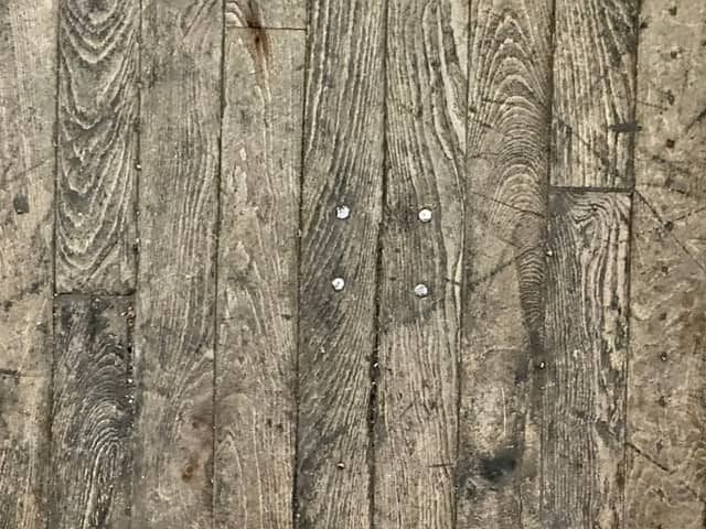 Worn hardwood floor boards needing repair